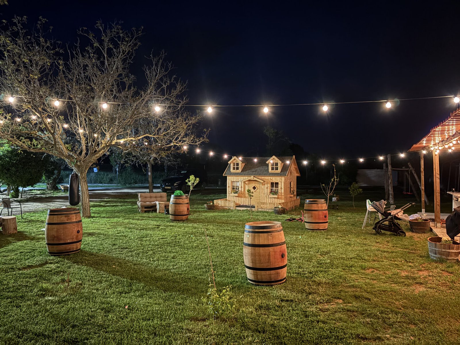 Jardín de noche con casita infantil